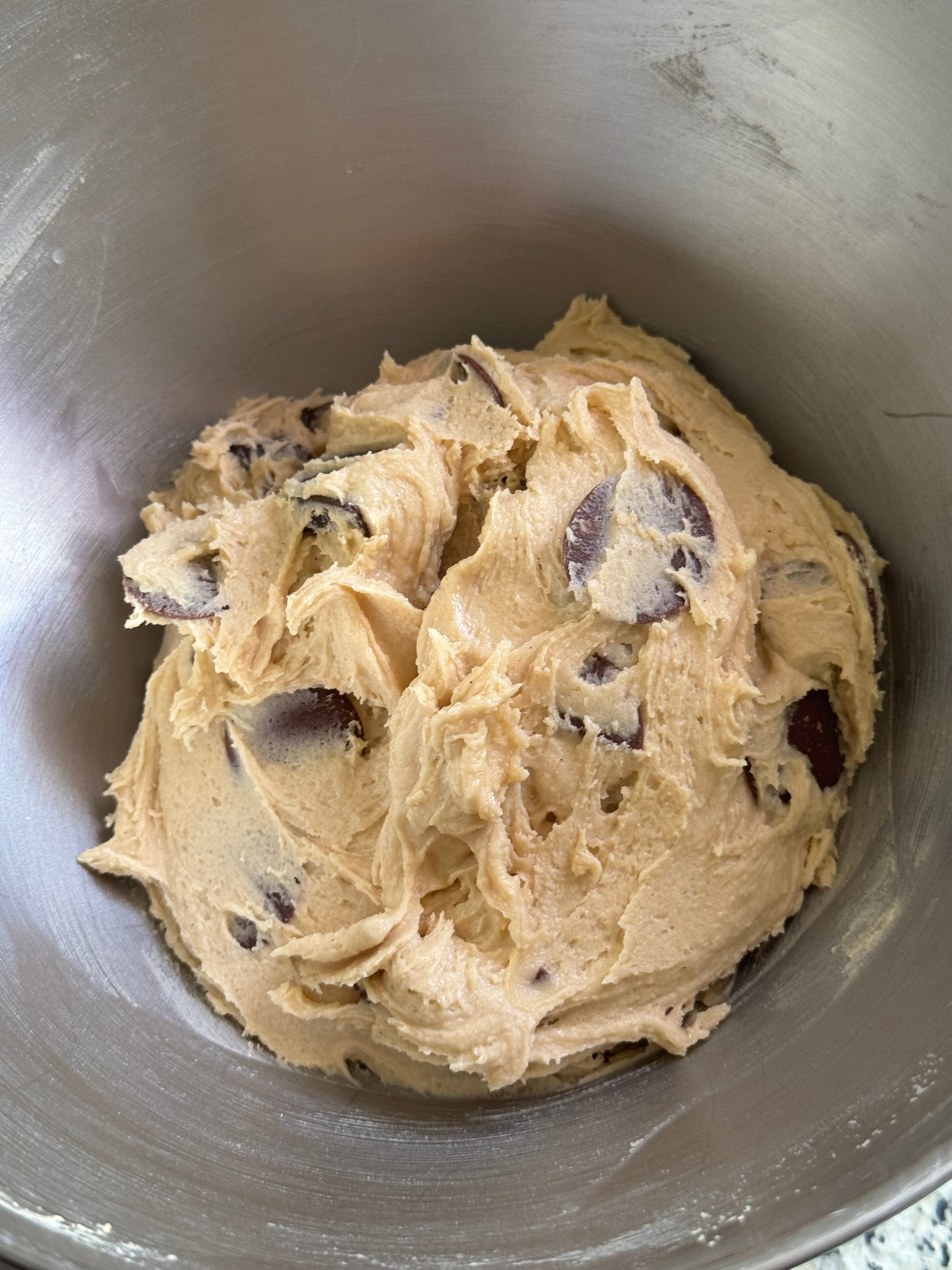 Cookie dough with chocolate chips in a mixing bowl
