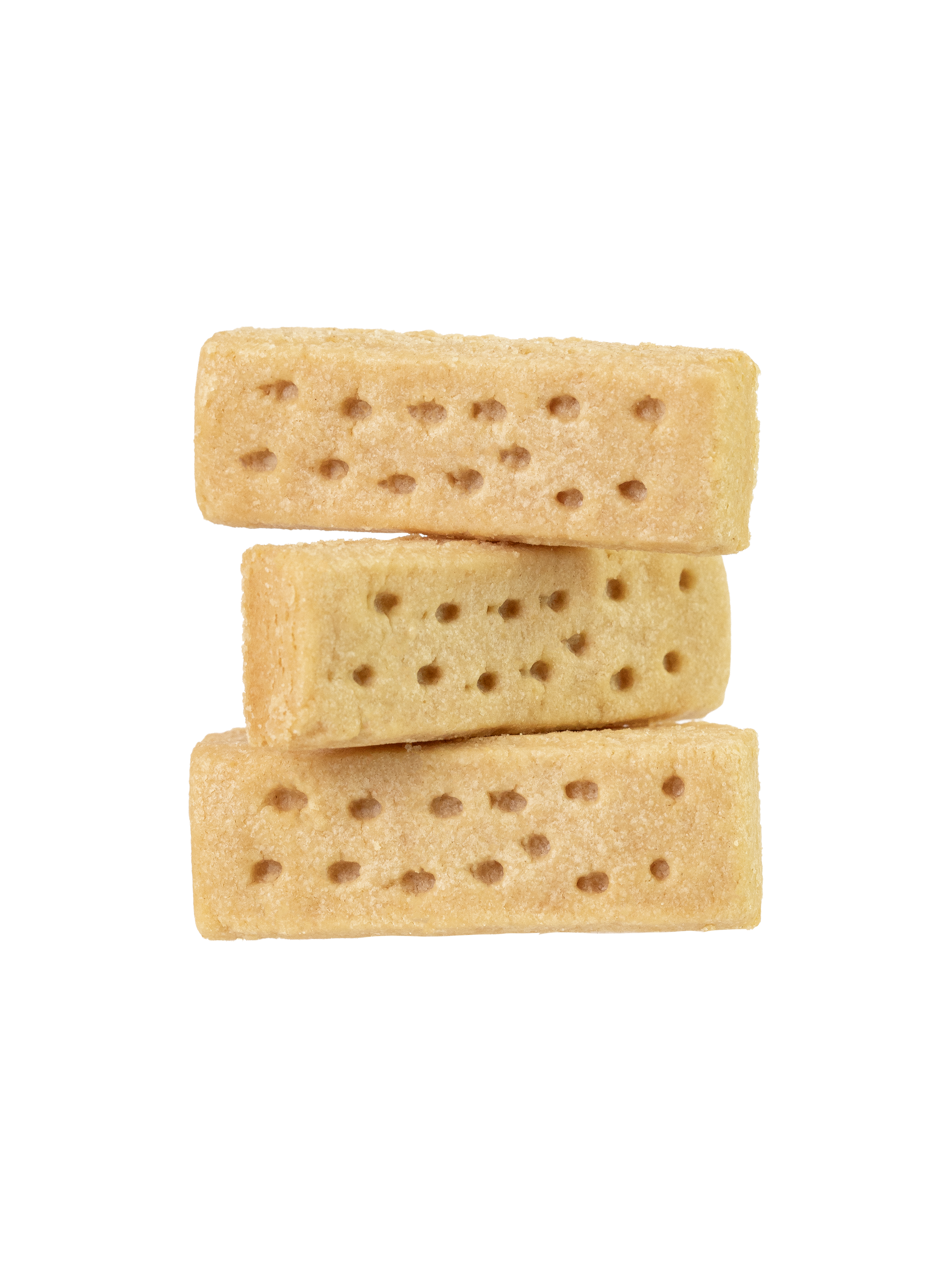 Stack of three uncooked gluten-free shortbread cookies with holes patterned on the surface
