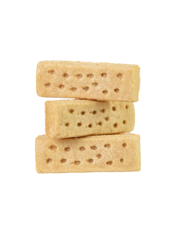 Stack of three uncooked gluten-free shortbread cookies with holes patterned on the surface